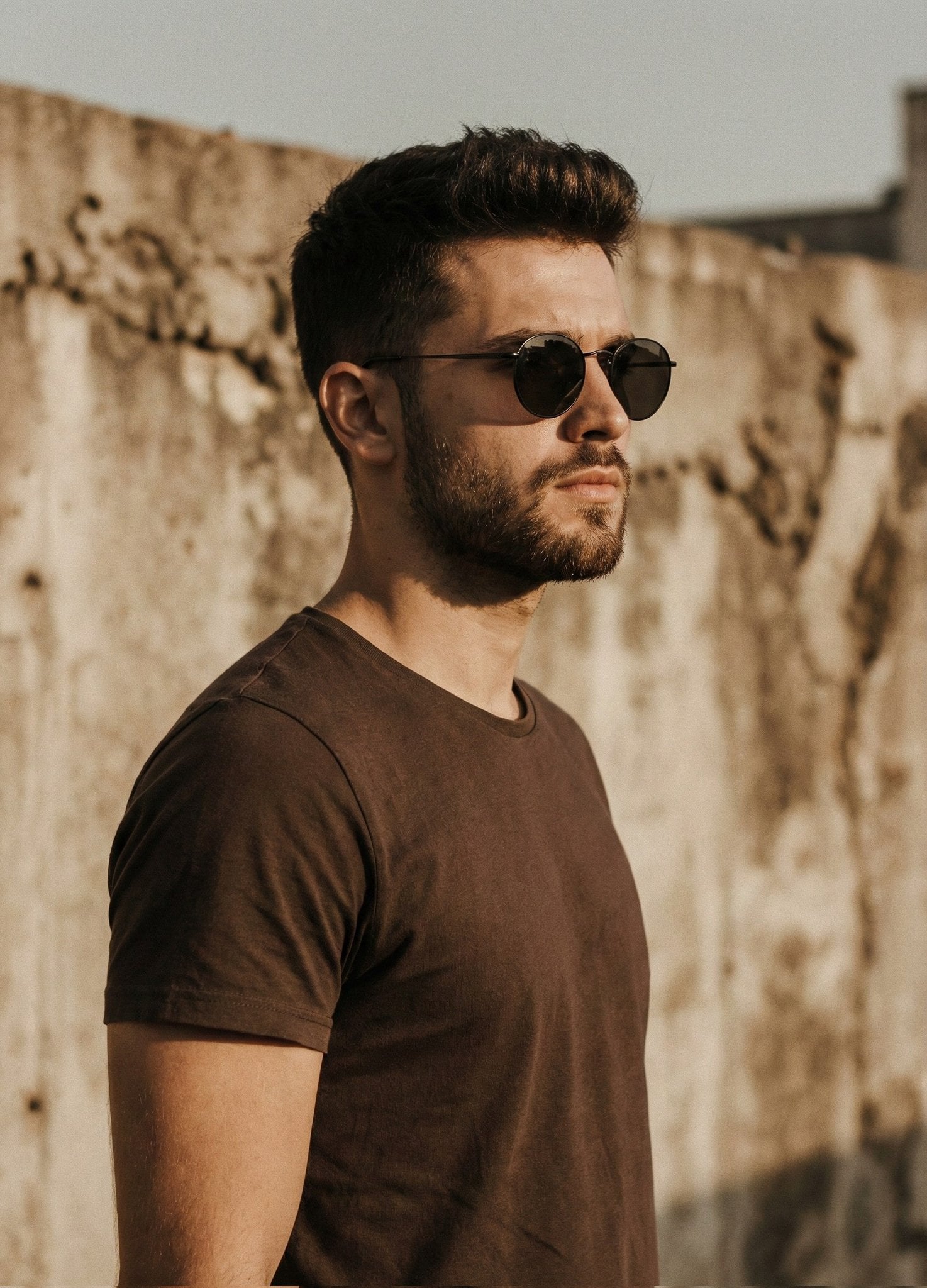 A cinematic portrait of a handsome man with a short styled haircut an…