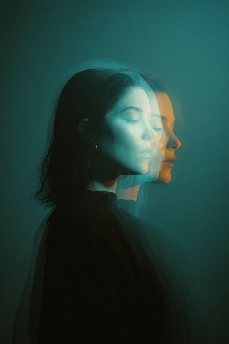 Cinematic double exposure portrait of a woman in side profile, two ov…