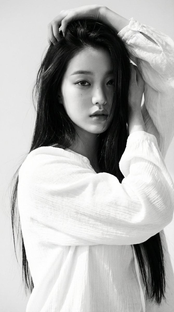 Black-and-white portrait of a young woman with long straight dark hai…