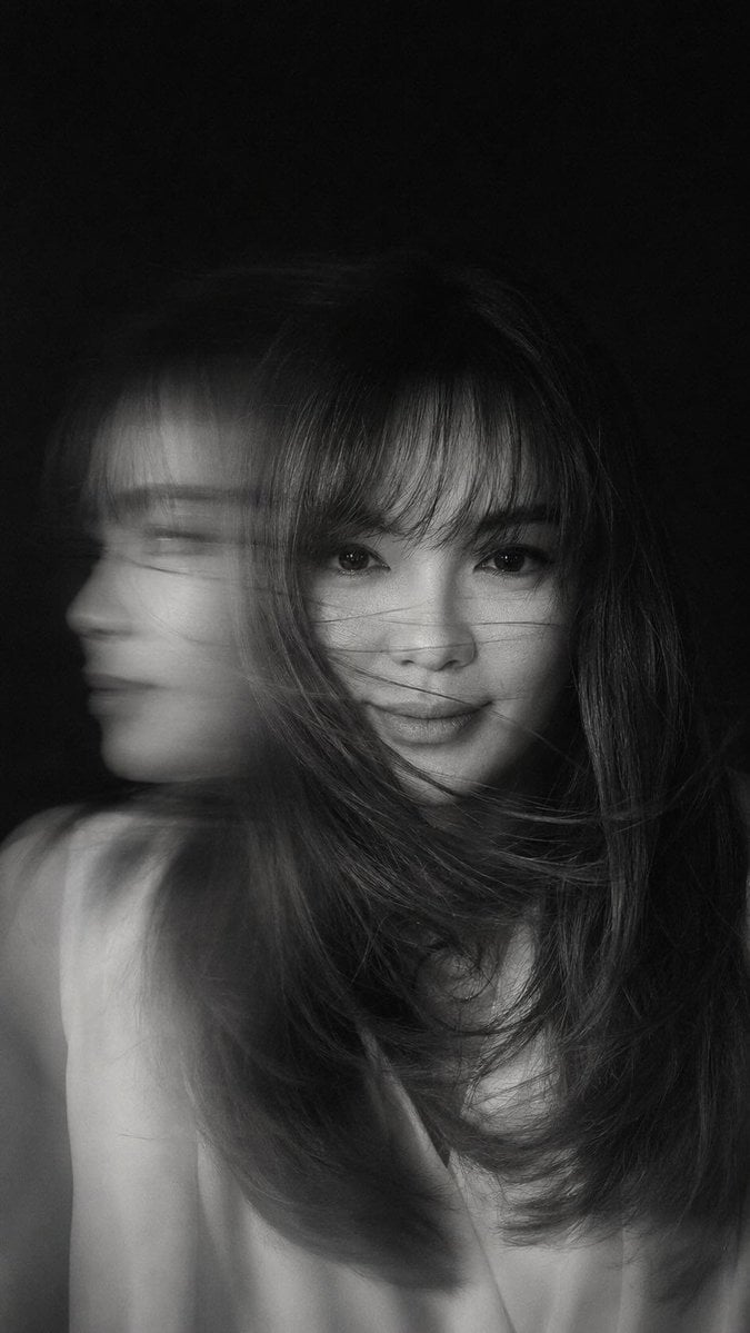 A hyper-realistic, cinematic black-and-white portrait of a woman caug…