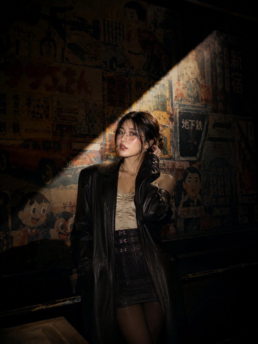 Cinematic nighttime portrait of a stylish young Asian woman standing…