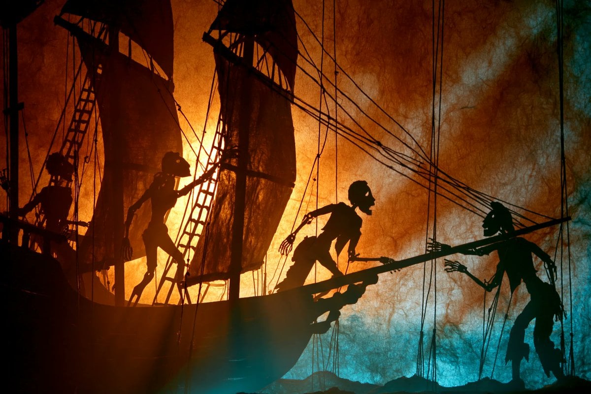 A theatrical shadow puppet scene of a [Subject], shown in stark silho…