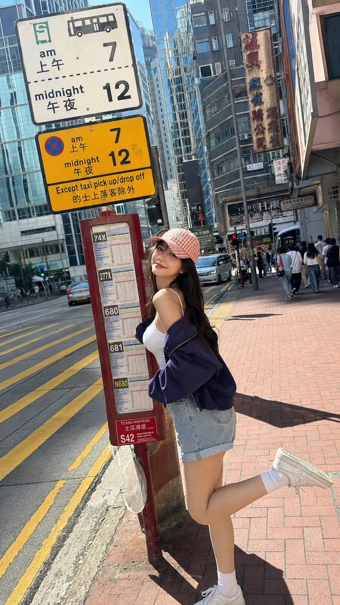 A realistic vertical 9:16 full-body smartphone street photo of a youn…