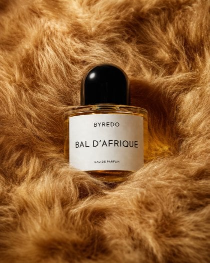 Create a luxurious editorial product photograph featuring one perfume…